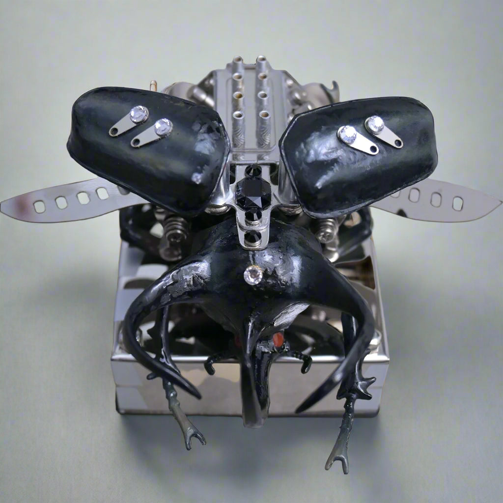 Mechanical beetle model kit with articulated wings that open to reveal a hidden V8 engine mechanism inside