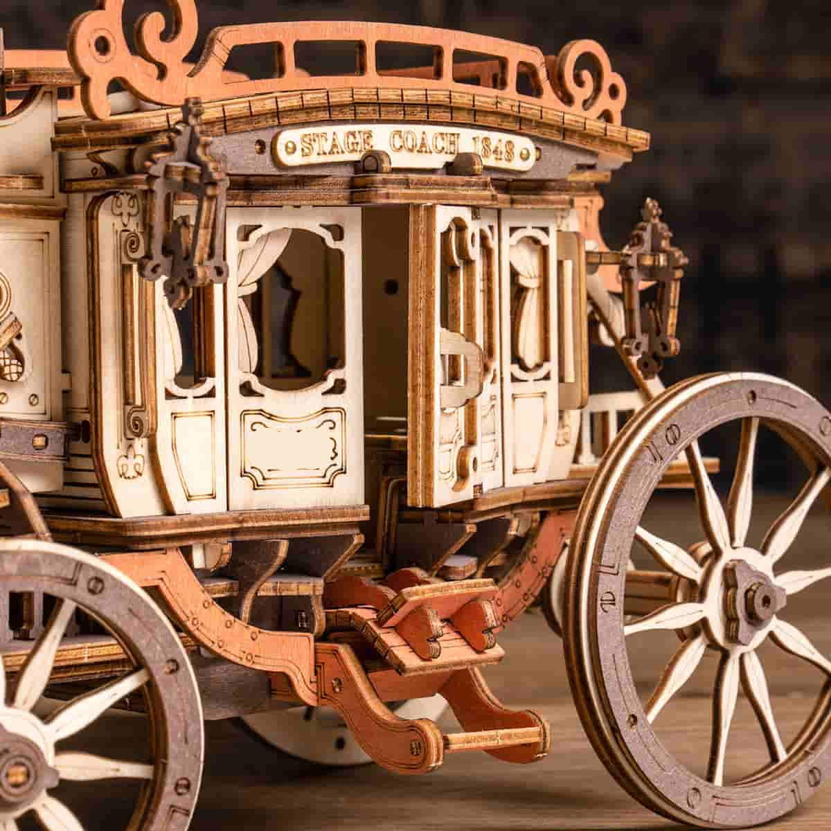 Horse drawn stagecoach model with carriage lamps and a luggage rack, vintage wooden music box playing the Greensleeves melody