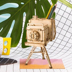 Playful wooden camera puzzle holding colored pencils as a bright desk accent, a screen free craft kit and gift for hobbyists