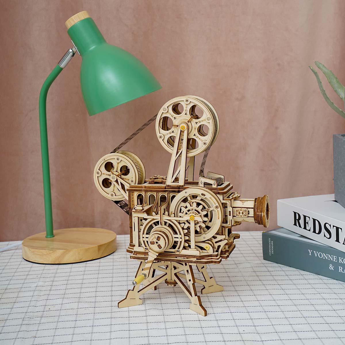 183 piece laser cut wooden puzzle that builds a working hand crank cinema projector, a screen free model kit for teens