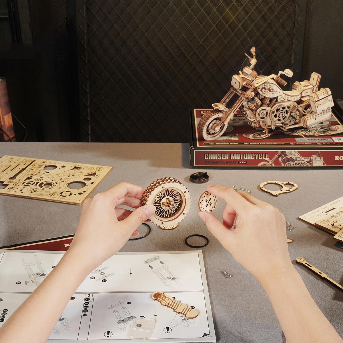 Building the wooden motorcycle puzzle by fitting laser cut gears, a screen free assembly project for teens and adults