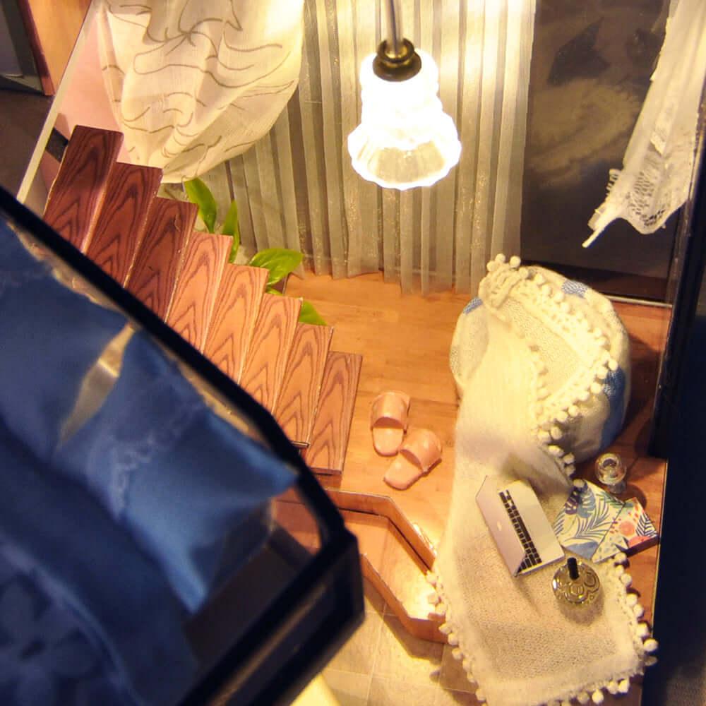 Cozy miniature lounge nook with a knit throw, slippers and laptop, a relaxing 1:24 dollhouse diorama for adults