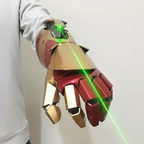 Mechanical glove with red and gold design, emitting green laser beams on a white background