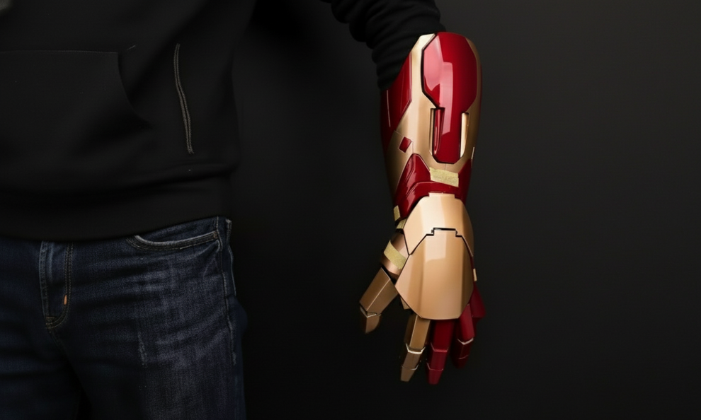 Person wearing a red and gold mechanical glove against a black background