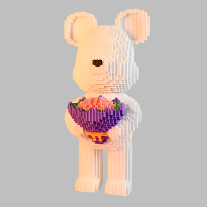 Toy bear holding a bouquet of flowers on a gray background