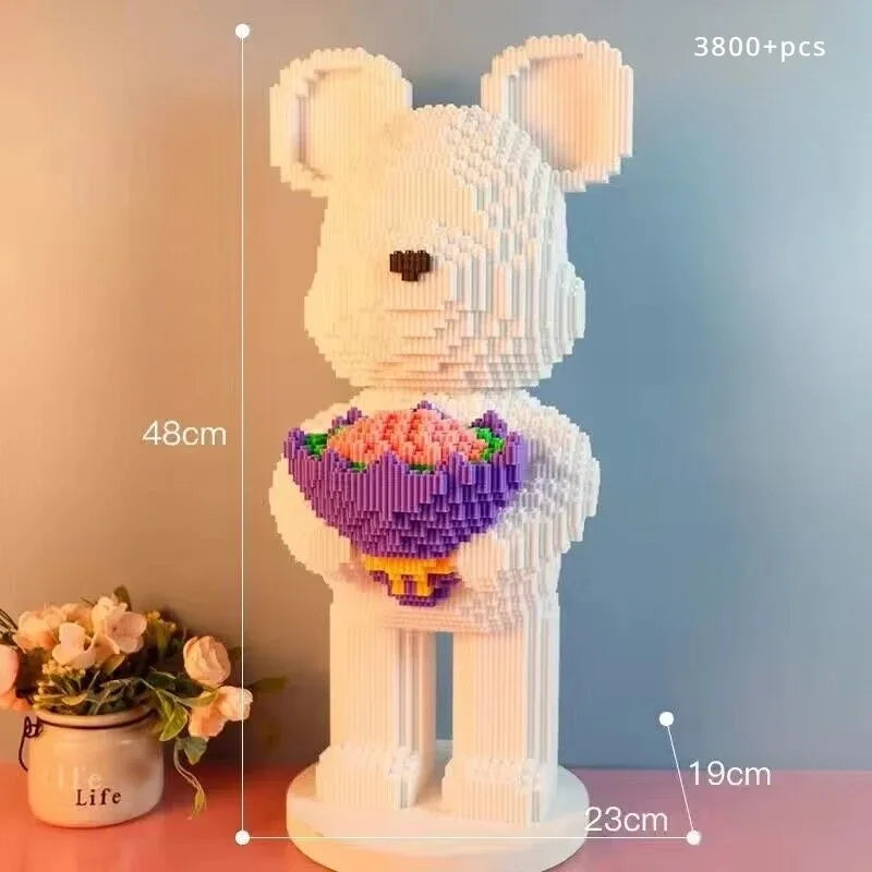 Teddy bear building block model with a bouquet, measurements indicated, on a gradient background.