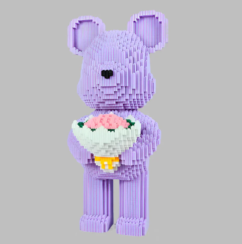 Purple teddy bear made of interlocking bricks holding a bouquet of flowers on a gray background