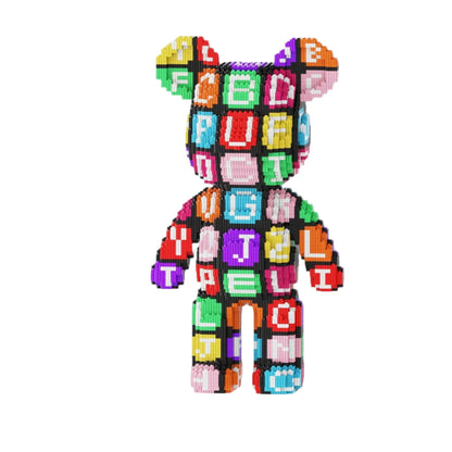 Colorful bear-shaped building block set with letter blocks on a white platform, surrounded by blue gift boxes.