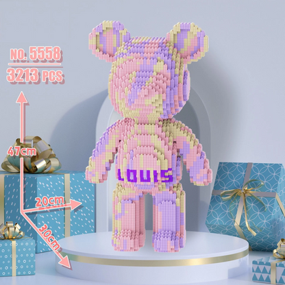 Colorful bear-shaped building block set on a white platform with gift boxes in the background