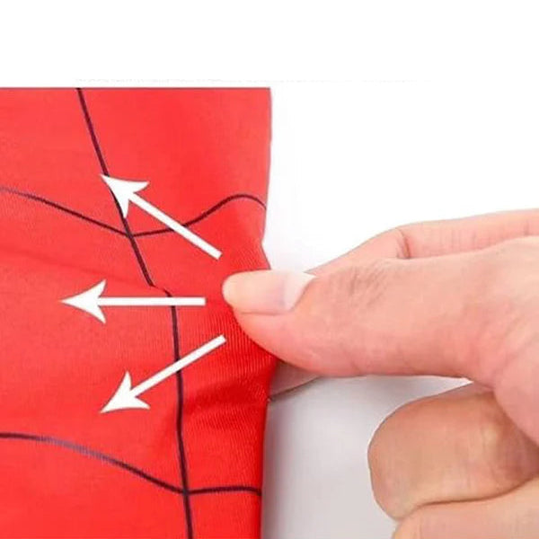 Red fabric with black lines and arrows, held by a hand on a white background