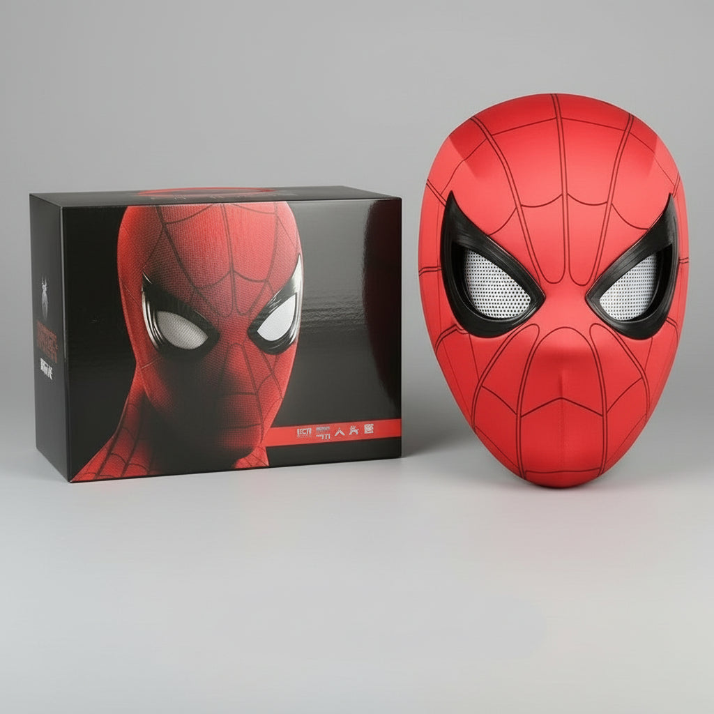 Red superhero spider man mask with black web patterns next to its packaging box on a gray background