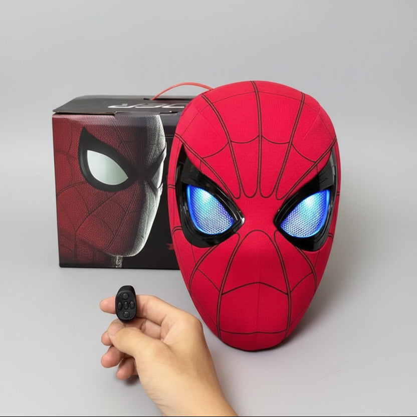 Spider-Man mask with glowing eyes and a remote control, against a gray background
